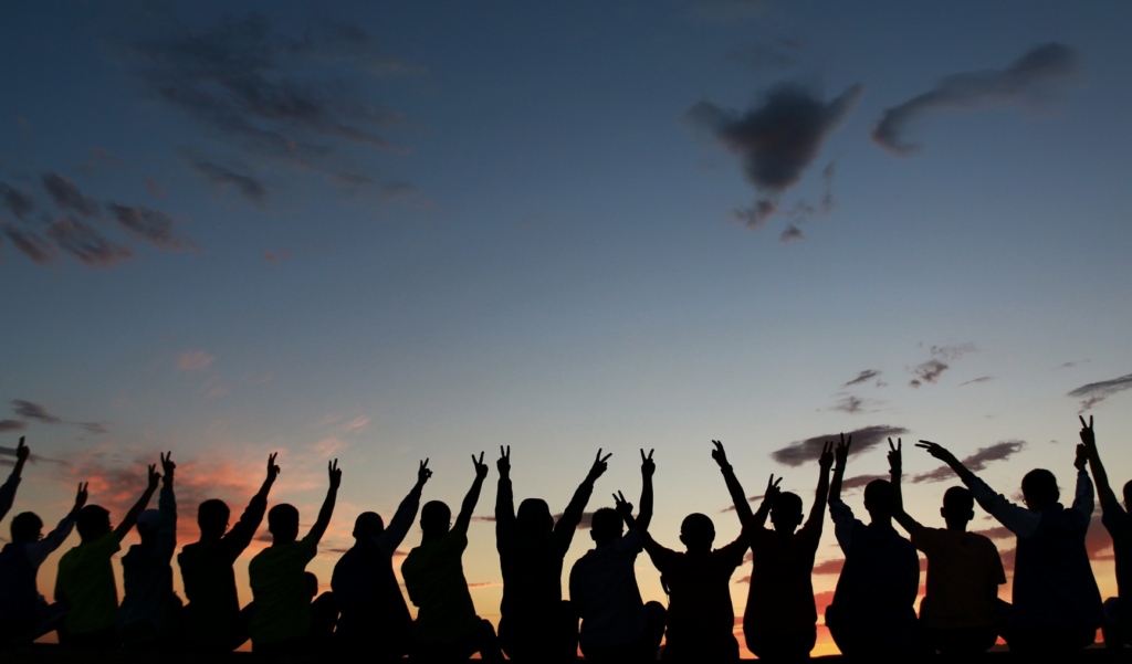 Team photo at sunset with shadows of people